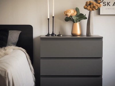 Black Chest Of Drawers In A Bedroom With A Black Window