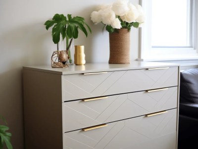 Gray Dresser With Gold Handles In Front Of A Couch