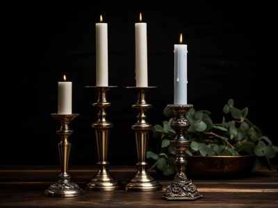 Three Metal Candles On Top Of A Wooden Table